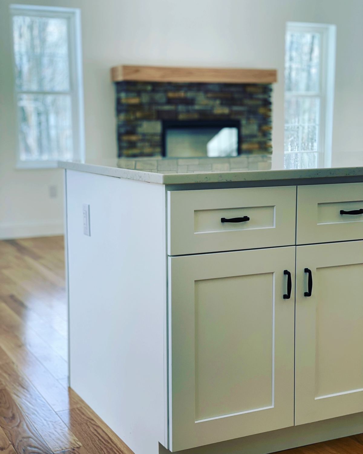 White shaker-style kitchen island with black pulls