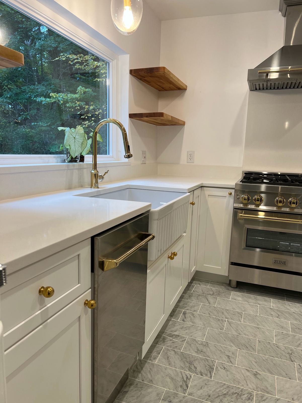 White kitchen cabinets with gold hardware, farmhouse sink and open shelves