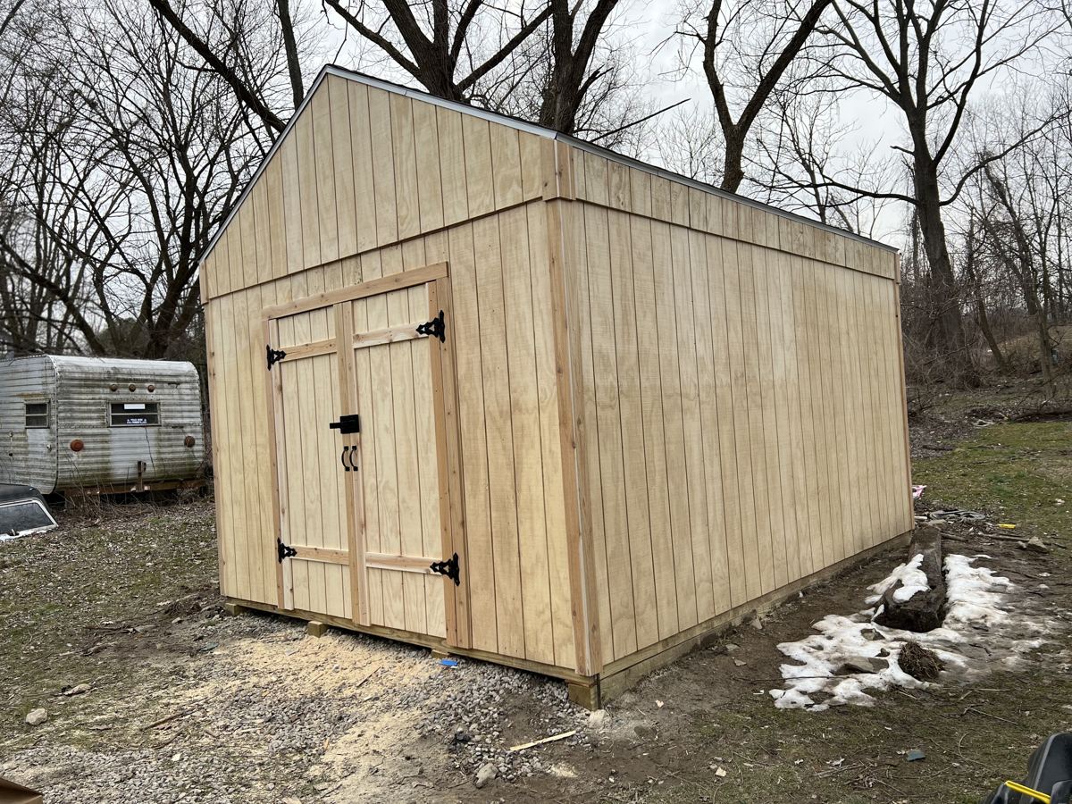 Newly built wooden shed with double doors